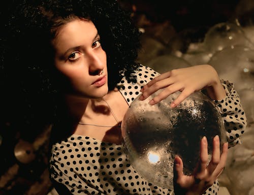 Portrait of Woman Holding Ice Sphere