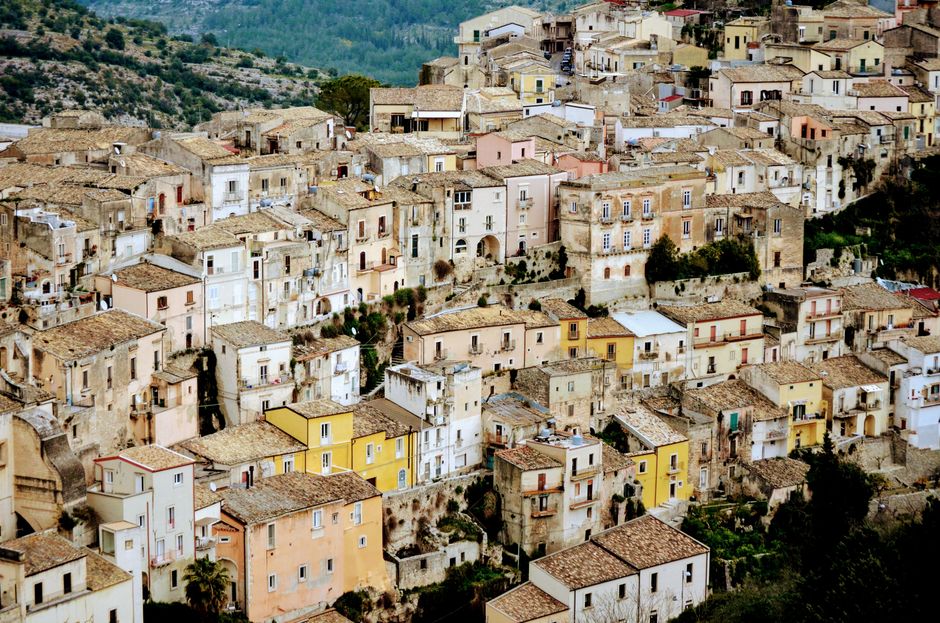 Charming aerial view of historic stone buildings in a picturesque Italian town.