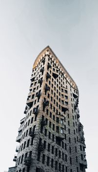 Low angle view of a unique modern skyscraper in Moscow, showcasing contemporary urban architecture.
