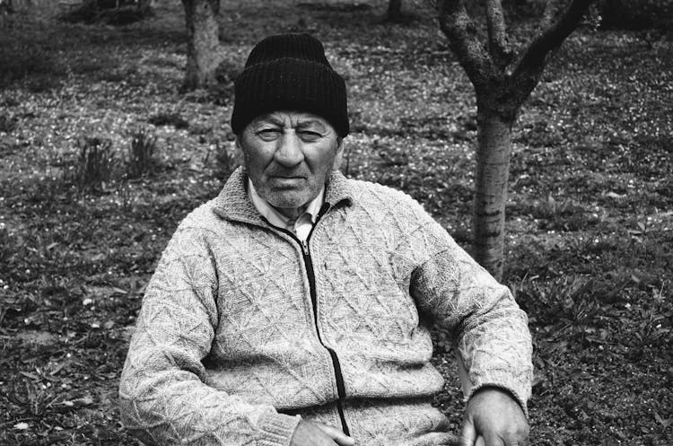 Elderly Man Sitting In Garden