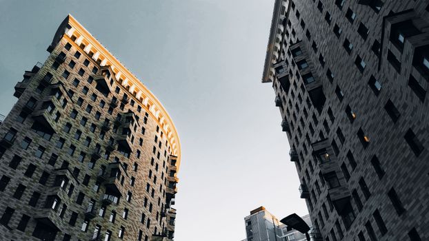 Low angle view of modern skyscrapers in Moscow with a clear evening sky.
