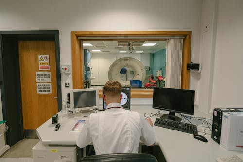 Doctor Sitting Behind Desk in Office