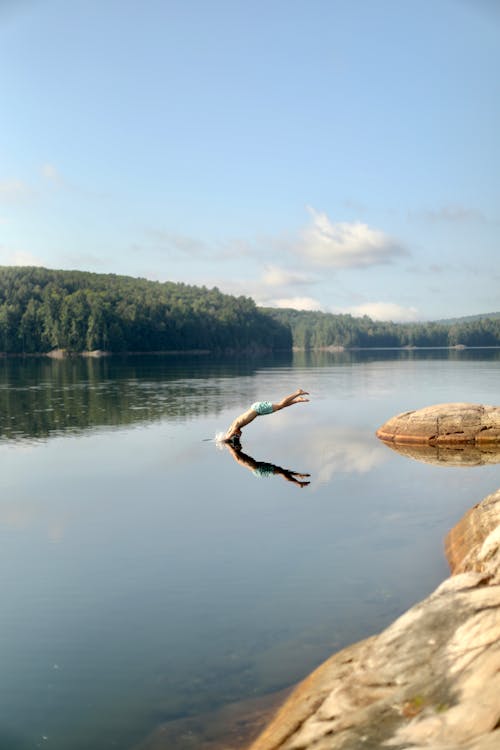 A Person Diving on the Lake