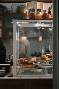 A close-up of freshly baked pastries in a cozy bakery with warm lighting, perfect for food lovers.