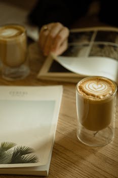 Warm setting with coffee cups and books on a wooden table. Perfect for relaxation.