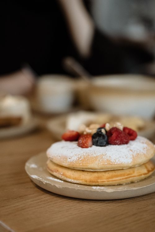 Free Close-up of pancakes topped with fresh berries and nuts, ideal for breakfast or dessert imagery. Stock Photo