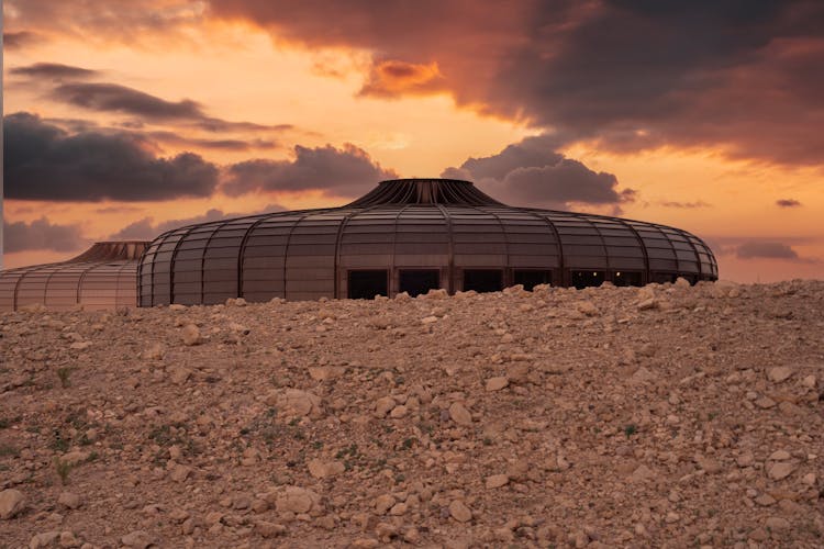 Modern Buildings In Desert On Sunset