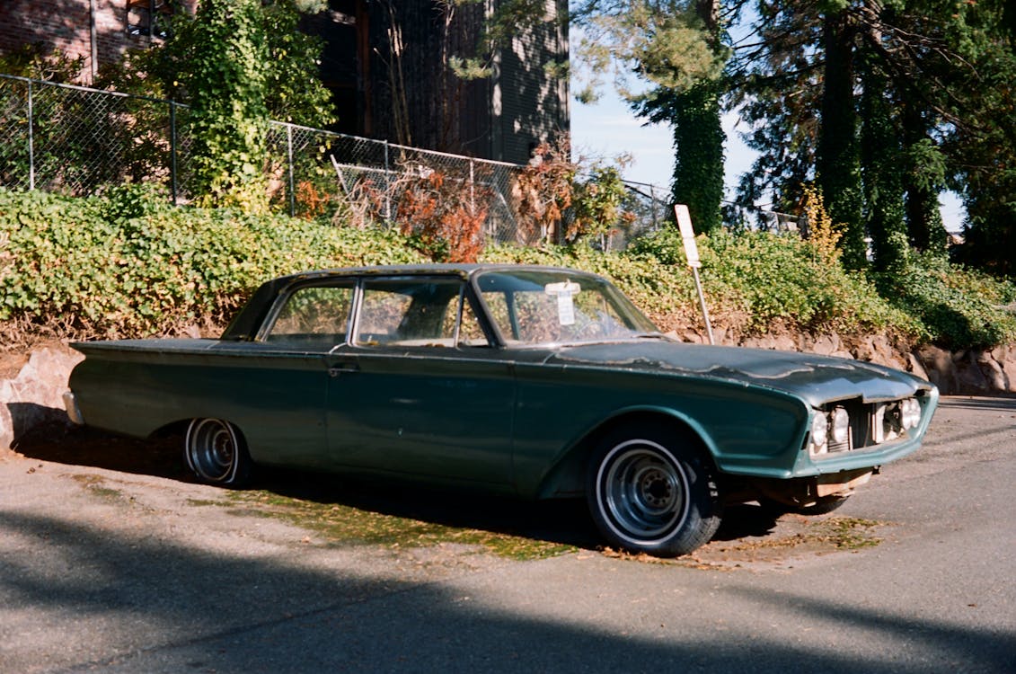 Photograph of a Green Abandoned Car