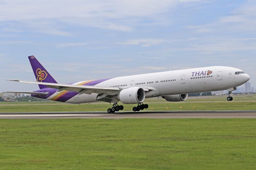 Thai Airways Boeing 777 landing on airport runway, showcasing aviation and transportation.