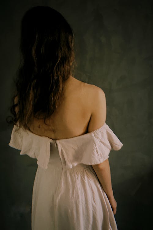 Back View of a Woman Wearing a White Dress