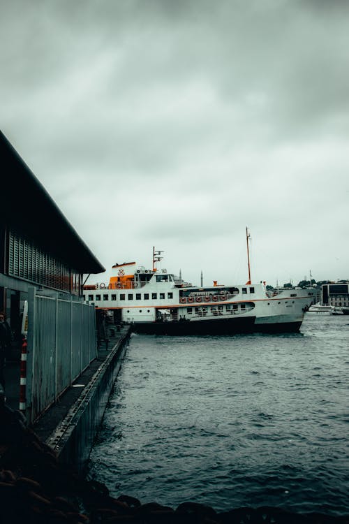 A Ferry Boat on the Dock under the Cloudy Sky