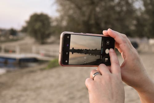 Free Close-Up Shot of a Person Taking Photos Using a Smartphone Stock Photo