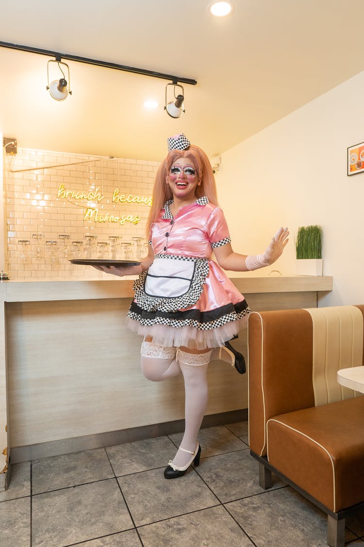 Drag Queen In Pink Costume Waiting Tables At Diner