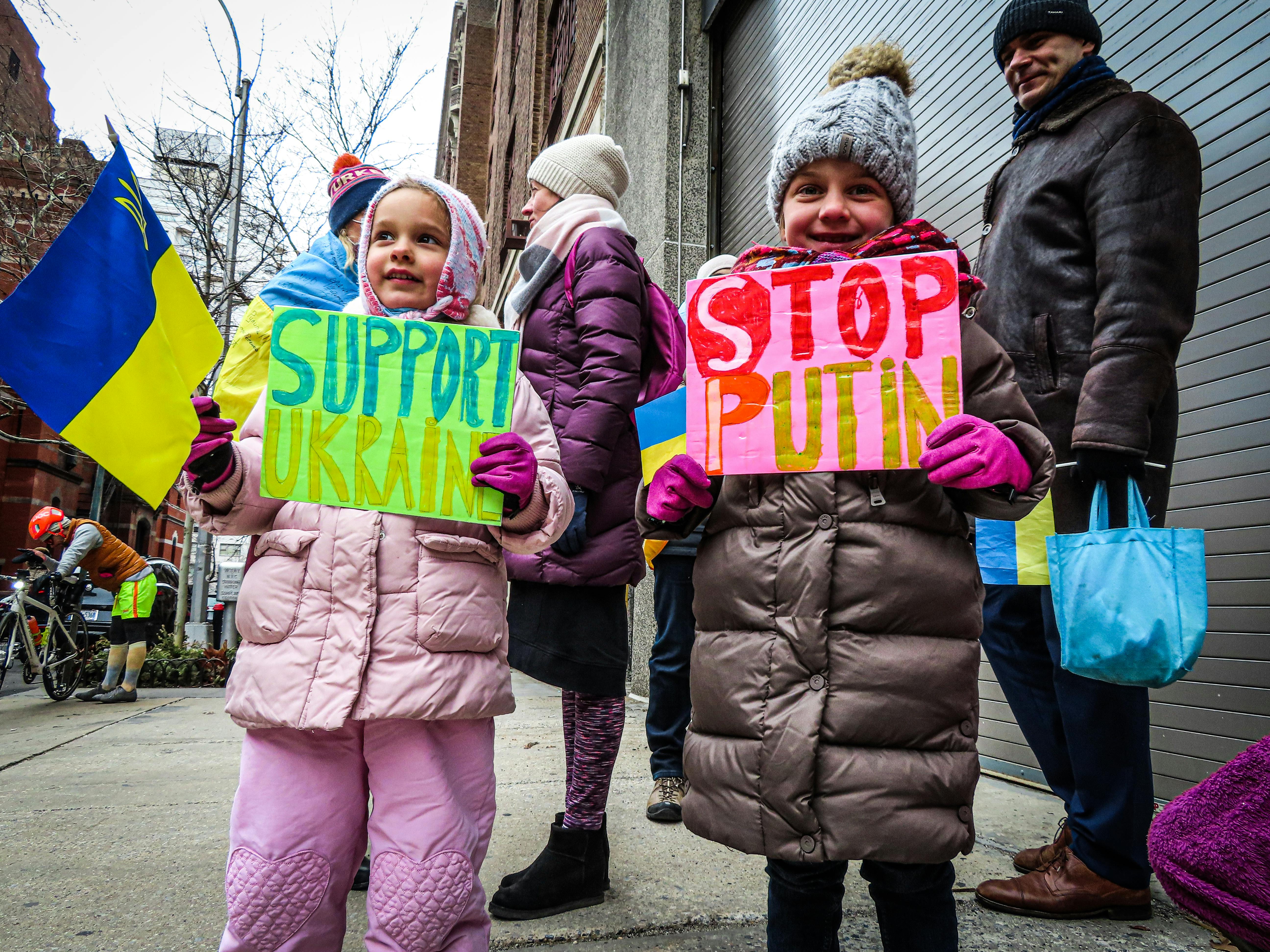 girls with signs on protest against russian war on ukraine