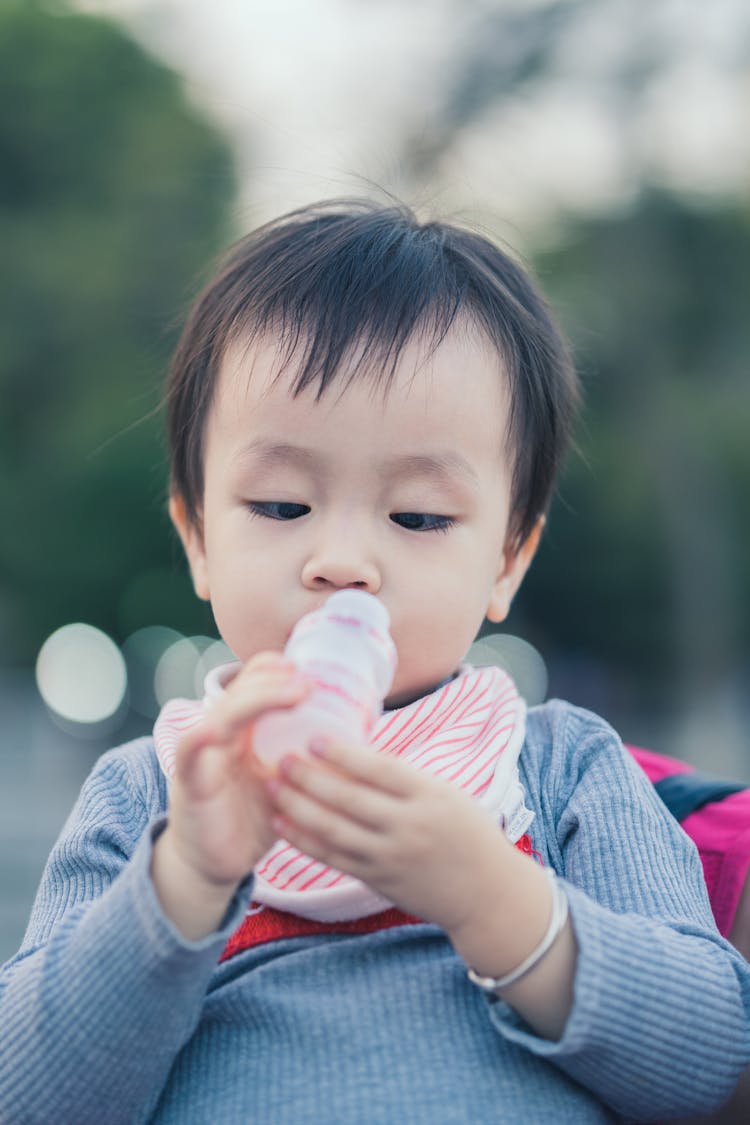 Baby Boy Holding Bottle