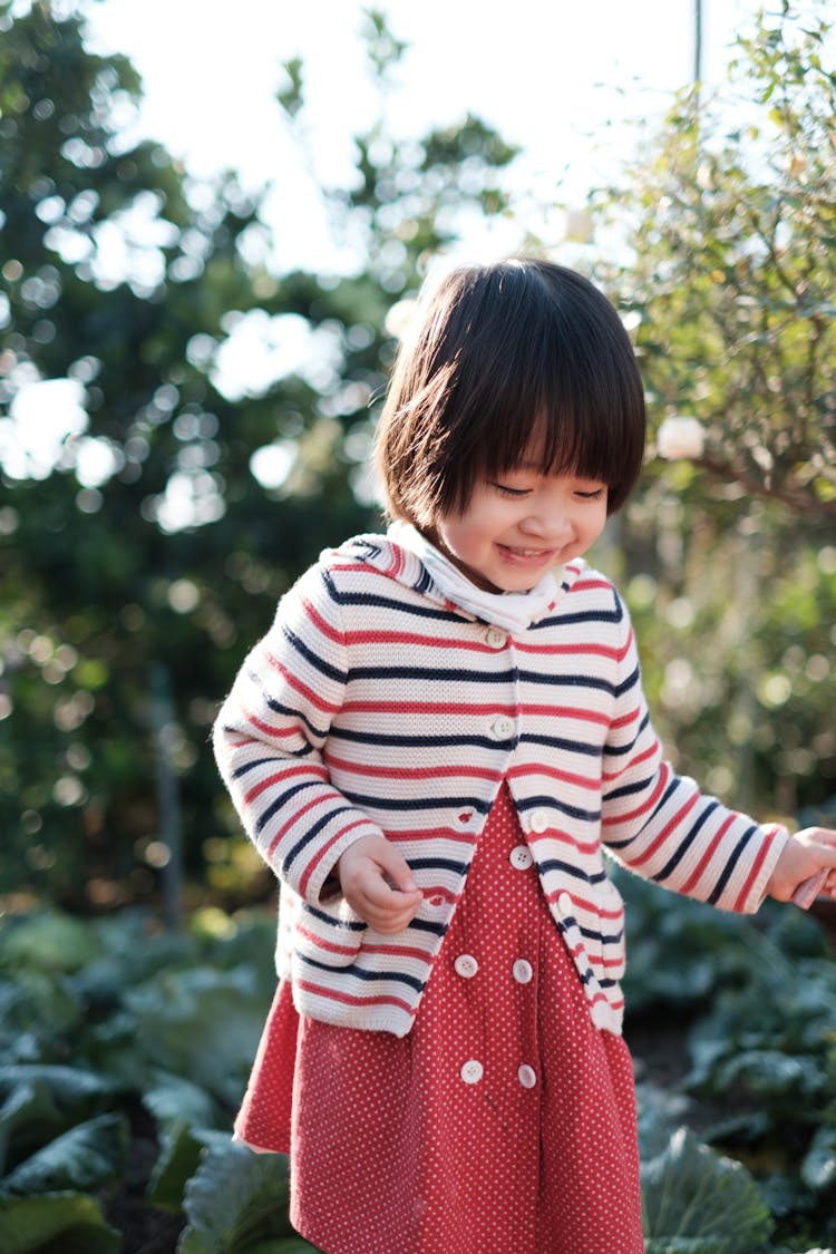 Child Standing Near Green Trees