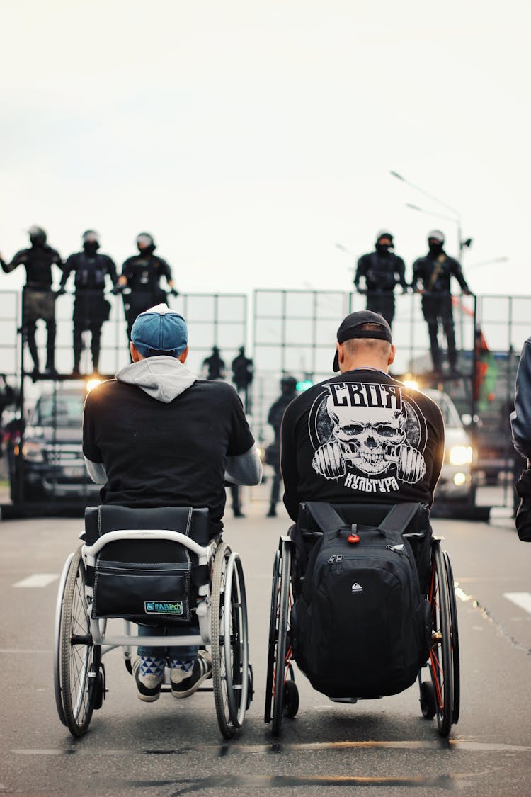 Back View Of Men On Wheelchairs On Protest