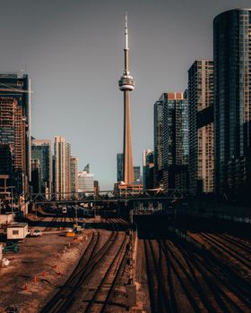 Iconic Toronto skyline with the CN Tower and urban architecture during sunset.