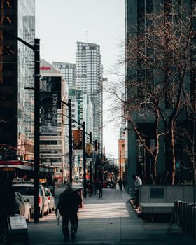 Urban street view in downtown Toronto with skyscrapers, pedestrians, and vibrant city life.