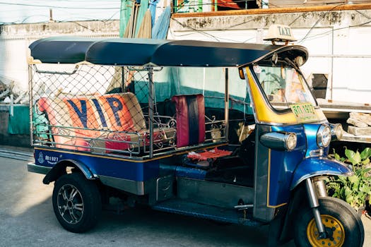 Colorful tuk tuk taxi parked on a bustling street in Bangkok, Thailand, capturing urban culture.