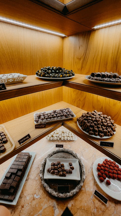 Assorted Chocolates on Brown Wooden Shelves