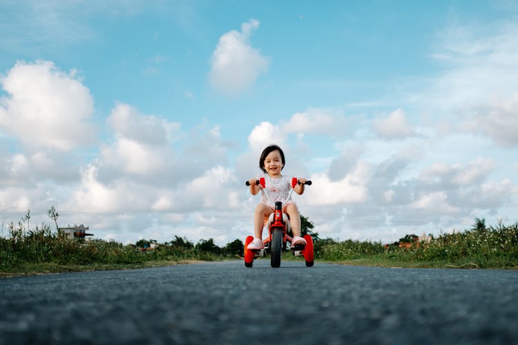 Young Girl Riding A Red Bike