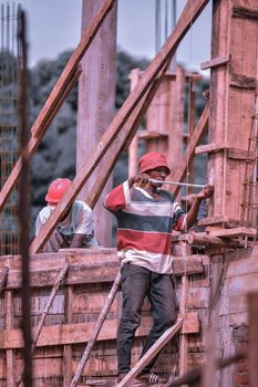 Hardworking construction workers building framework on construction site outdoors.
