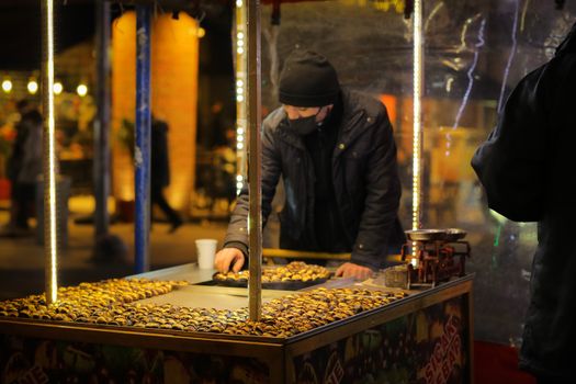 Night scene of a vendor selling roasted chestnuts on the streets of Istanbul.
