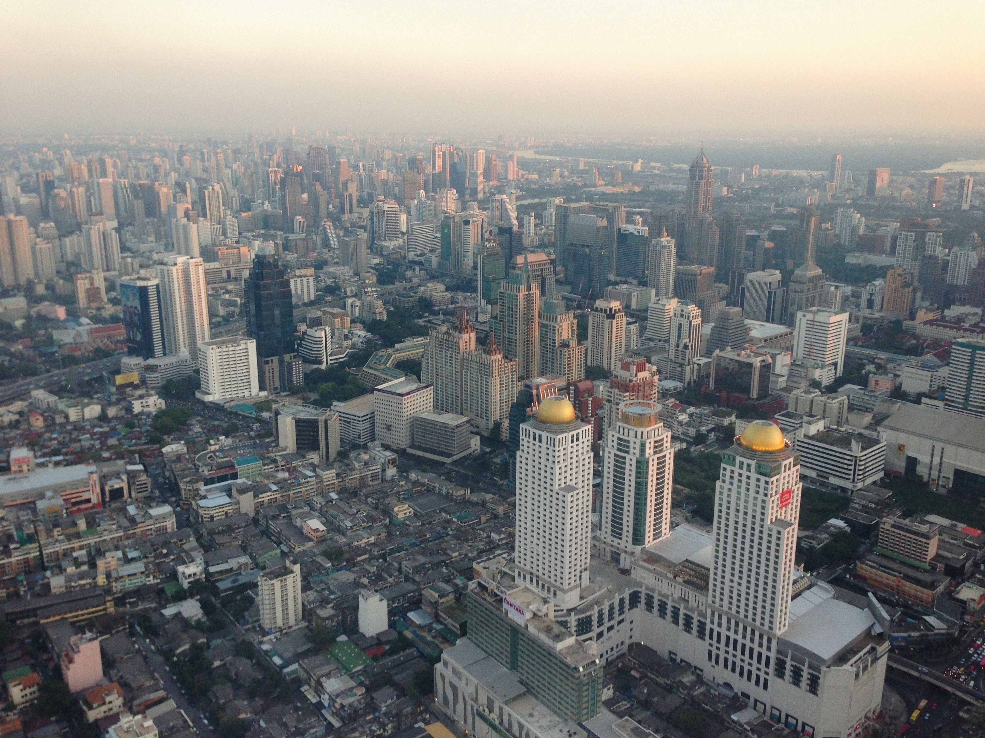 Stunning aerial view of Bangkok's dense urban skyline featuring modern skyscrapers.