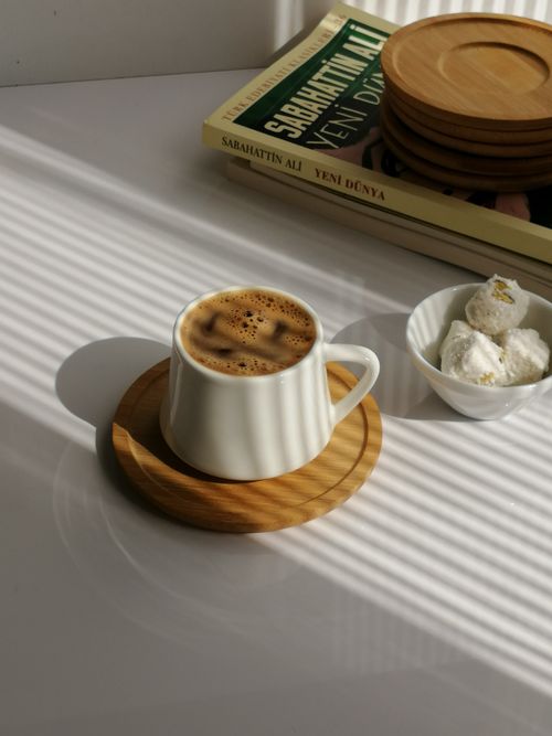 Free Warm morning light on Turkish coffee, books, and snacks, creating an inviting aesthetic. Stock Photo