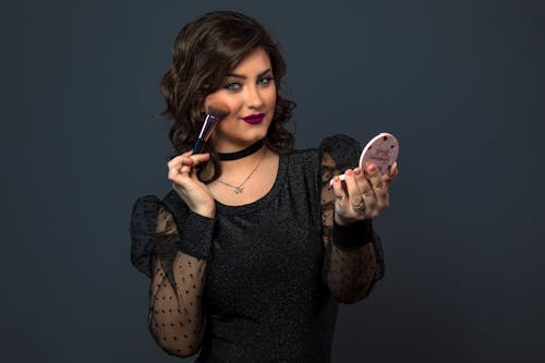 A Woman Holding a Makeup Brush