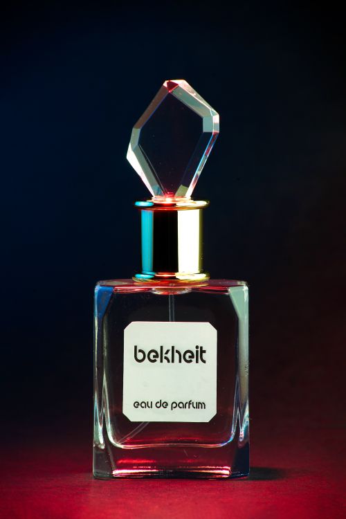 Free Elegant perfume bottle with a crystal cap captured in a vibrant studio shot. Stock Photo