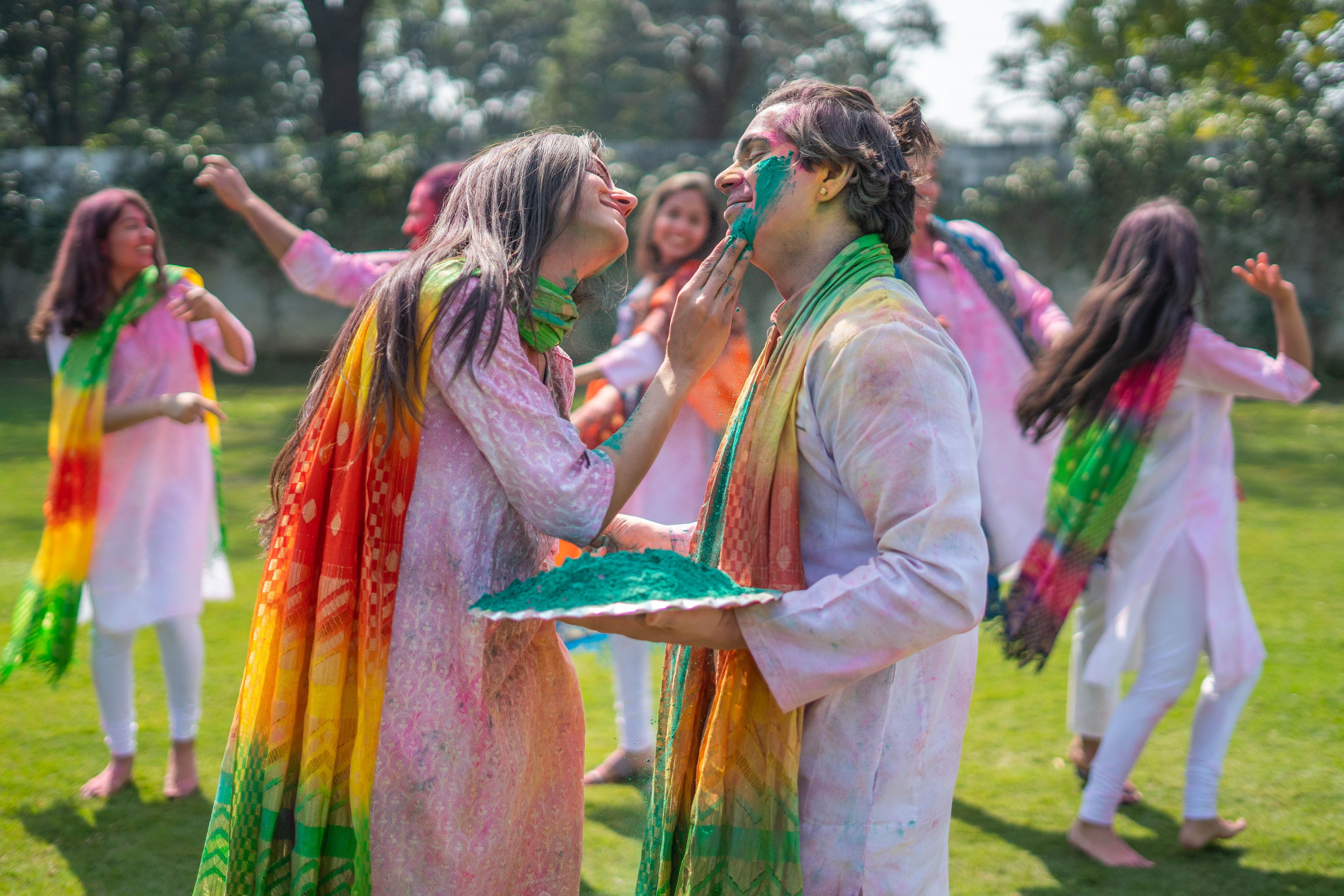 Colourful Holi festival celebration with people covered in bright powders