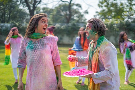 A vibrant and joyful Holi celebration with people covered in colorful powders, outdoors.