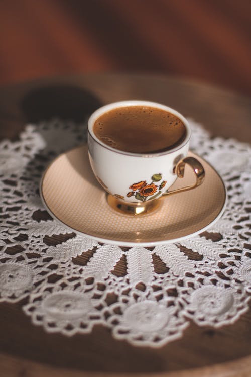 Free A White Floral Cup on Saucer Filled With Coffee Stock Photo