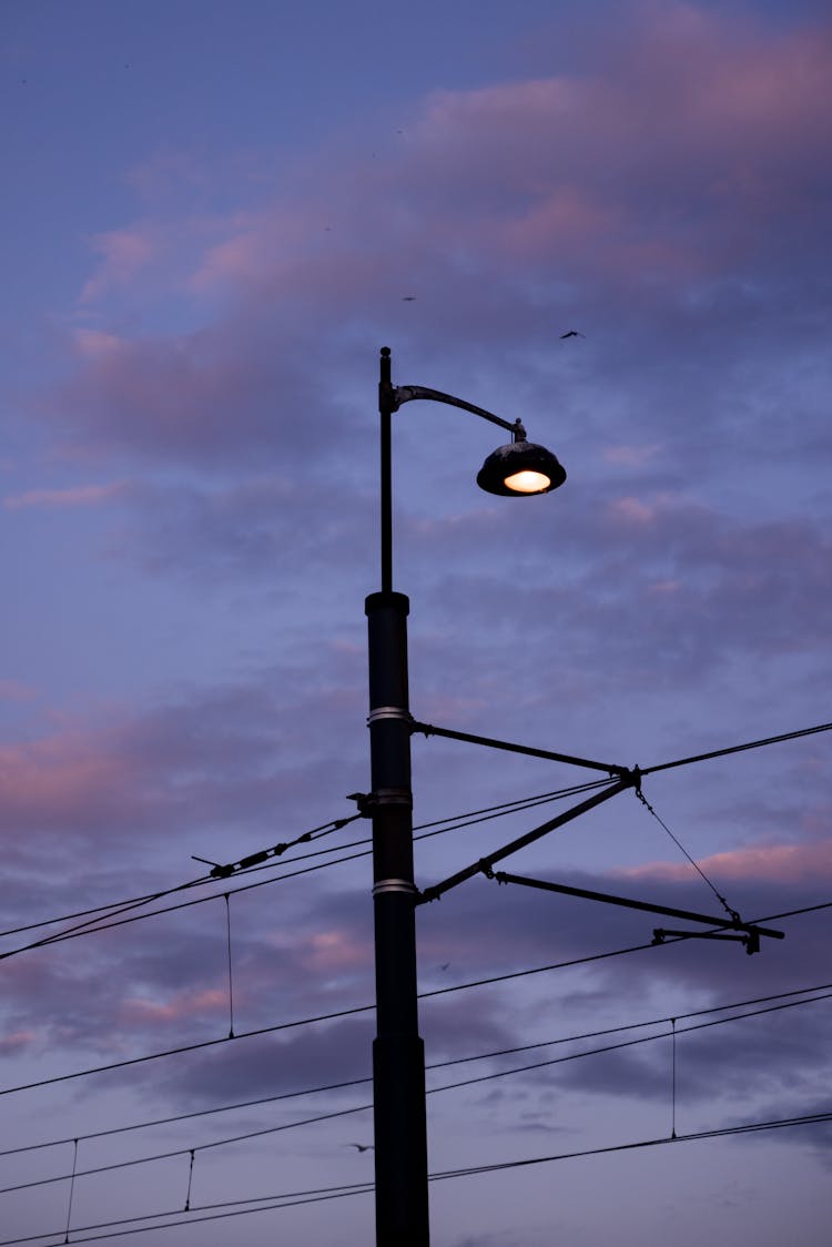 A Black Street Light Under Gray Clouds