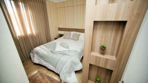 Free A cozy modern bedroom with neutral tones, soft lighting, and stylish decor for a relaxing ambiance. Stock Photo