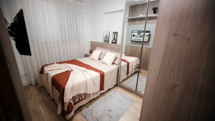 A White And Brown Bed Linen In A White Room