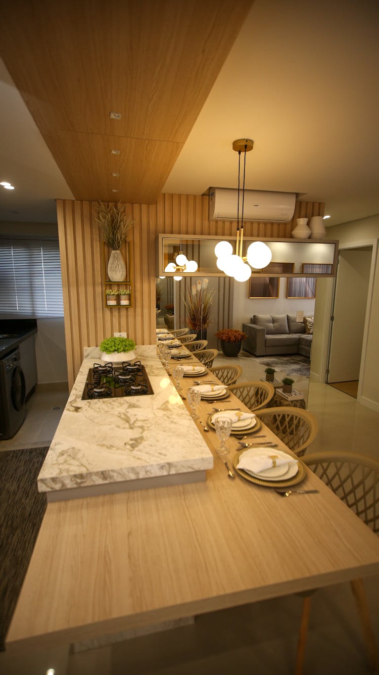 A Brown Wooden Dining Table With Chairs And Dining Wares