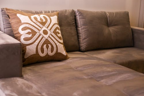 Brown and White Throw Pillow on the Couch