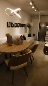 Stylish modern apartment dining room featuring chic furniture and decor.