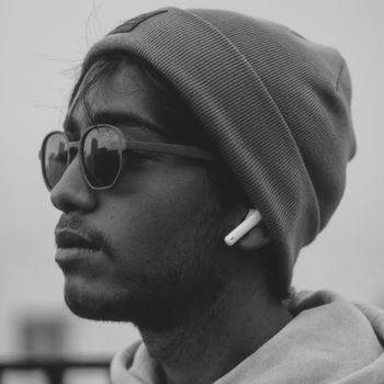 Monochrome portrait of a young man wearing a beanie and sunglasses in Marrakech.