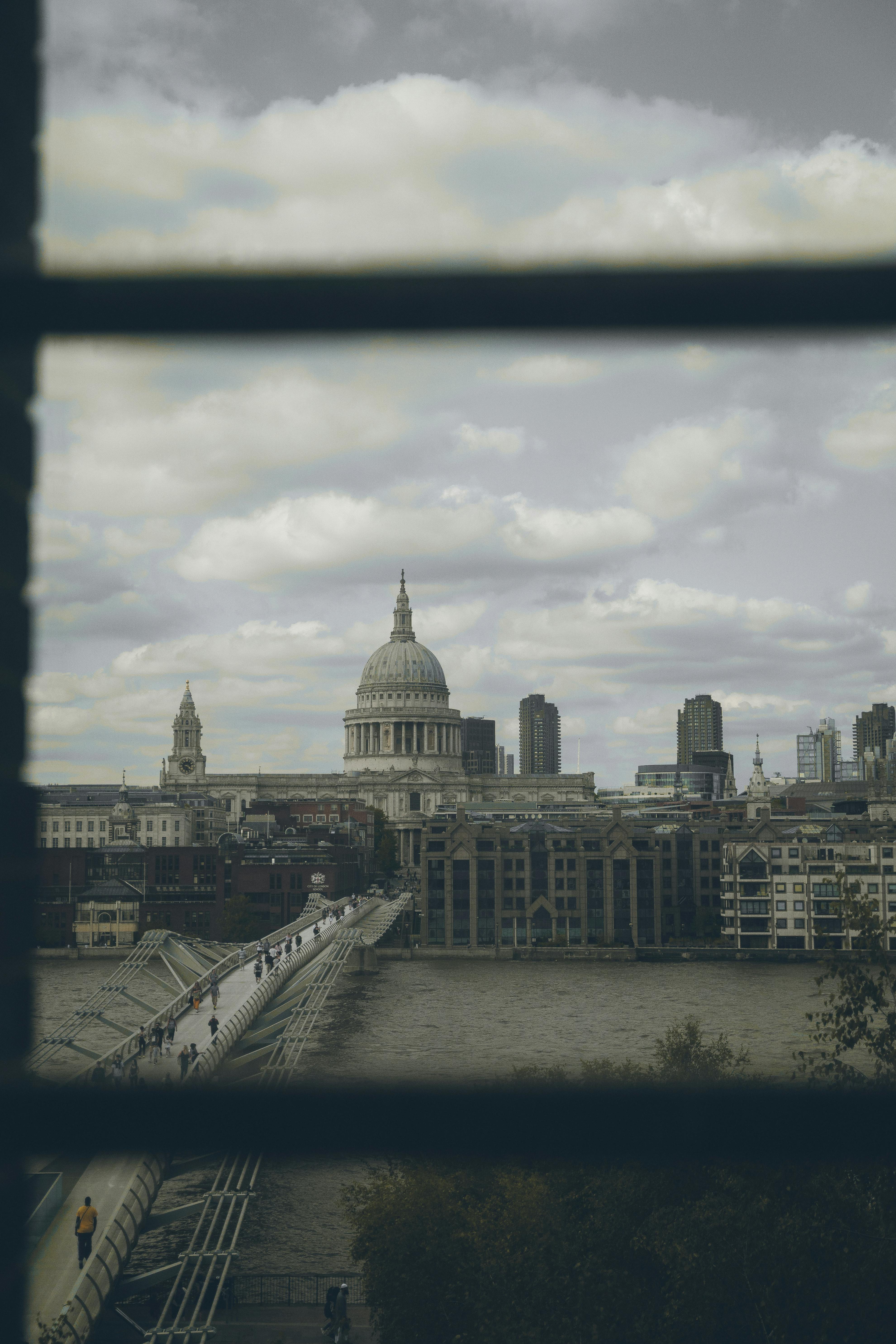 View of St. Paul's Cathedral from a window with Millennium Bridge in foreground, London.