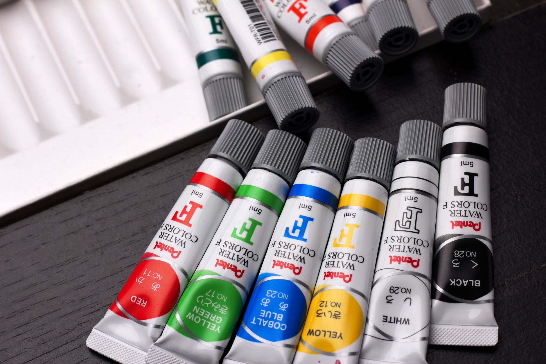 Colourful watercolour paint tubes in a creative setup