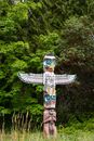 A  Wooden Totem Surrounded by Green Trees