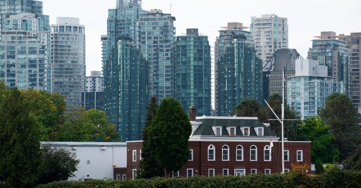 The Vancouver skyline with modern skyscrapers and a historic building in the foreground.