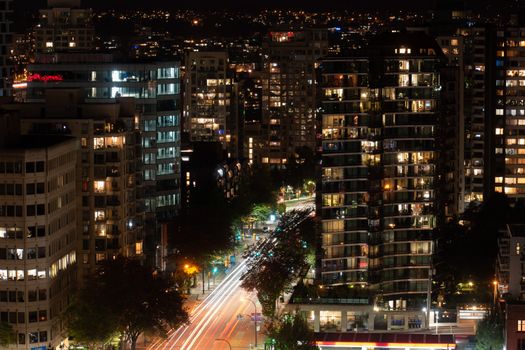 Stunning night view of Vancouver's downtown with light trails and illuminated buildings.