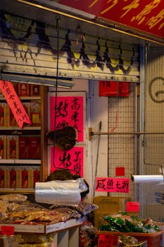A vibrant outdoor market stall selling traditional dried goods with eye-catching signage.