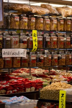 Vibrant market scene showcasing jars of spices and dried foods in a bustling shop.