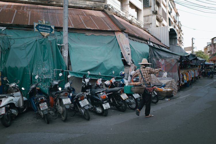 Man Walking By Rows Of Motorcycles